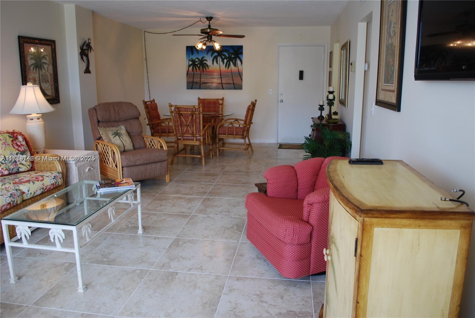 125 South Ocean Avenue, Unit 214 Palm Beach Shores, FL 33404 - Photo 12 of 26 a living room with furniture and a table