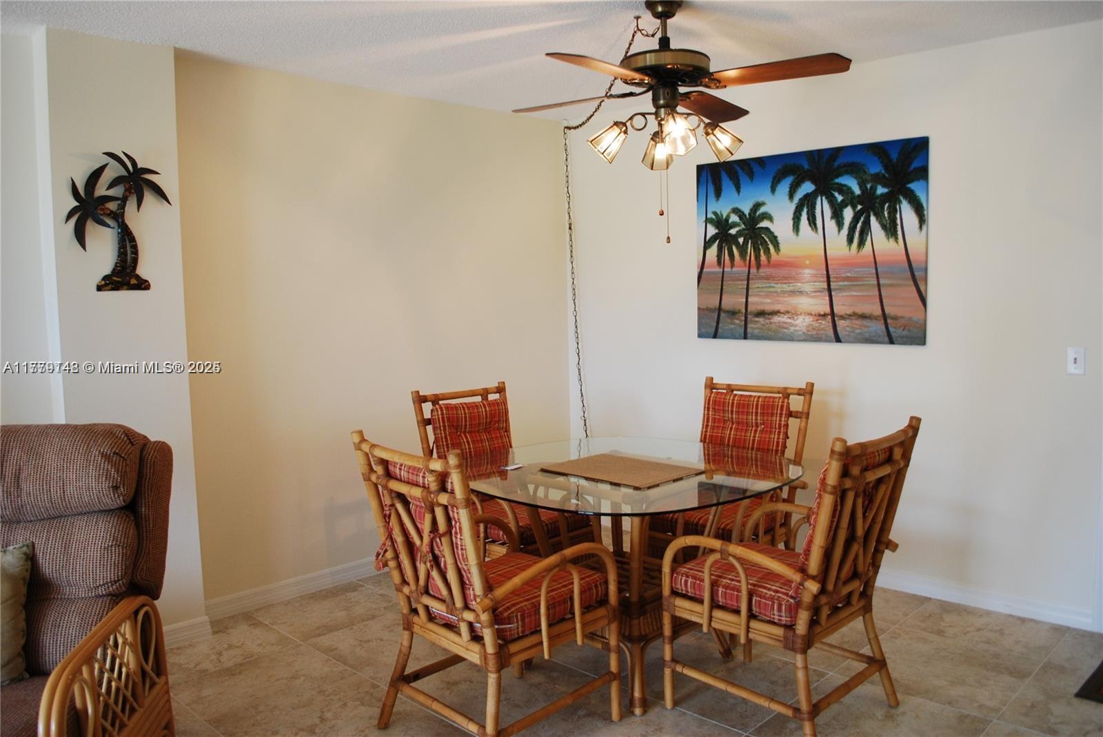 125 South Ocean Avenue, Unit 214 Palm Beach Shores, FL 33404 - Photo 13 of 26 a view of a dining room with furniture and chandelier