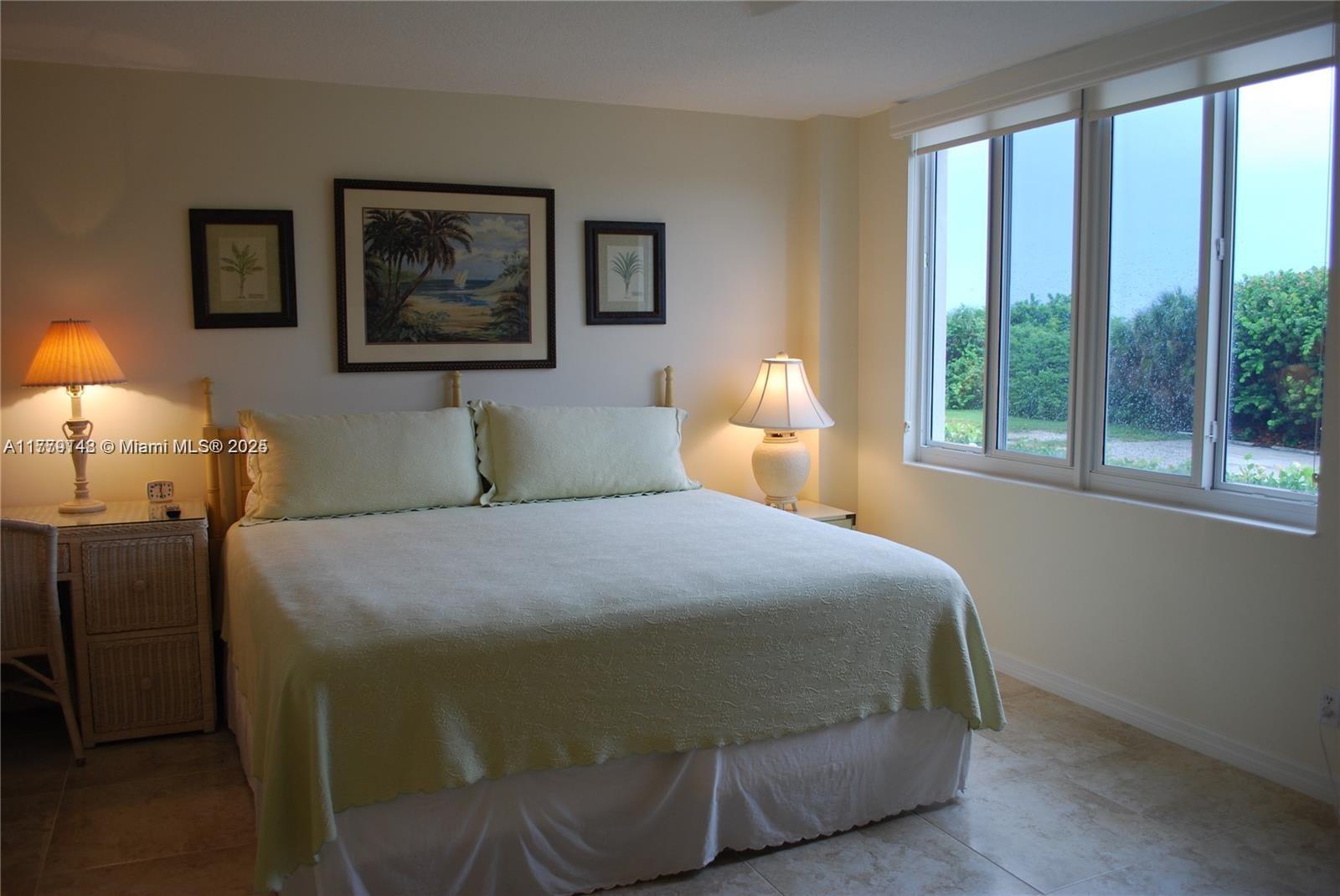 125 South Ocean Avenue, Unit 214 Palm Beach Shores, FL 33404 - Photo 17 of 26 a bedroom with a bed and a window