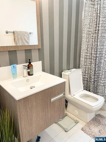 a white toilet sitting next to a bathroom sink