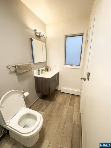 a bathroom with a toilet a sink and mirror