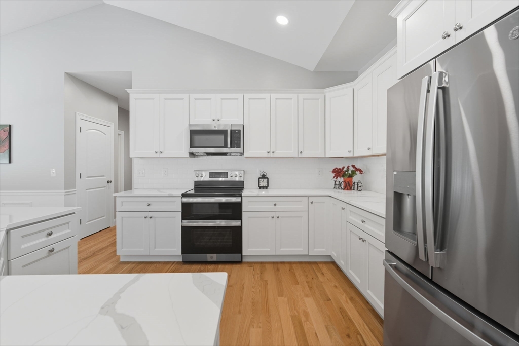 31 High Blf Road Belchertown, MA 01007 - Photo 13 of 36 a kitchen with white cabinets and stainless steel appliances