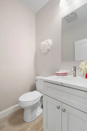 a bathroom with a toilet sink and mirror
