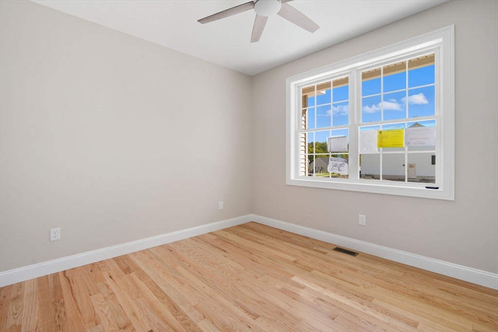 31 High Blf Road Belchertown, MA 01007 - Photo 17 of 36 a view of an empty room with a window and wooden floor