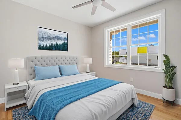 a bedroom with a bed and a window