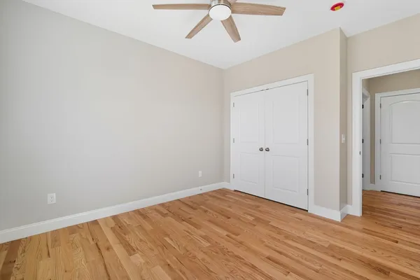 a view of empty room with wooden floor