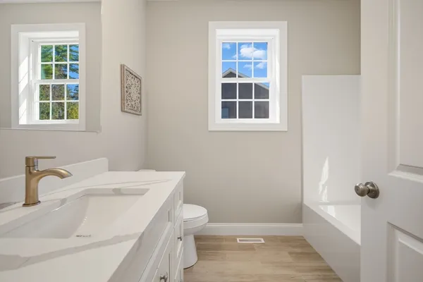 a bathroom with a sink toilet and shower