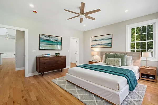 a bedroom with a bed dresser and a window