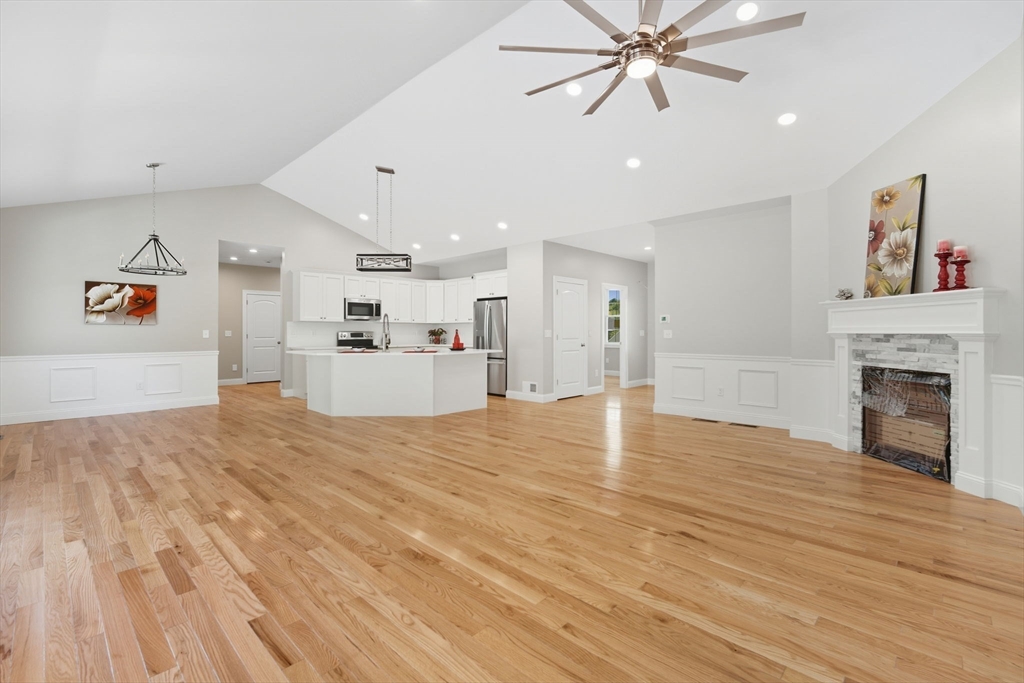 31 High Blf Road Belchertown, MA 01007 - Photo 9 of 36 a view of a livingroom with a kitchen and a ceiling fan