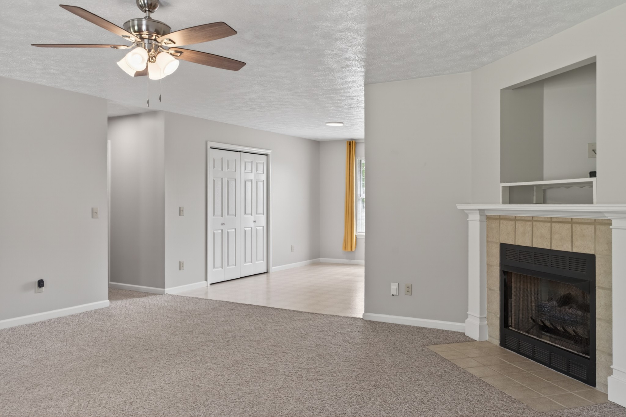 618 Lear Road Portland, TN 37148 - Photo 12 of 29 a view of an empty room with chandelier fan and fire place