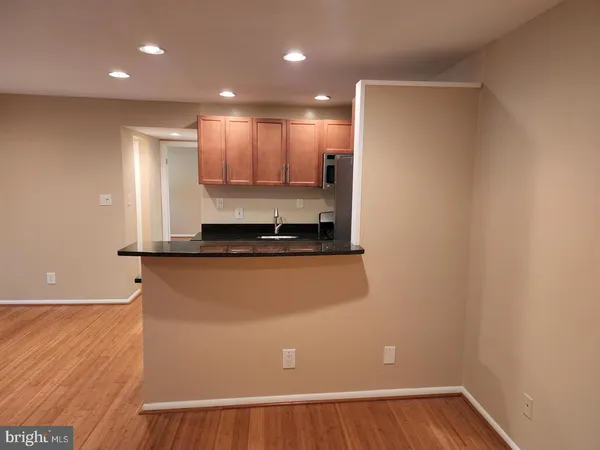 a view of a refrigerator with wooden floor