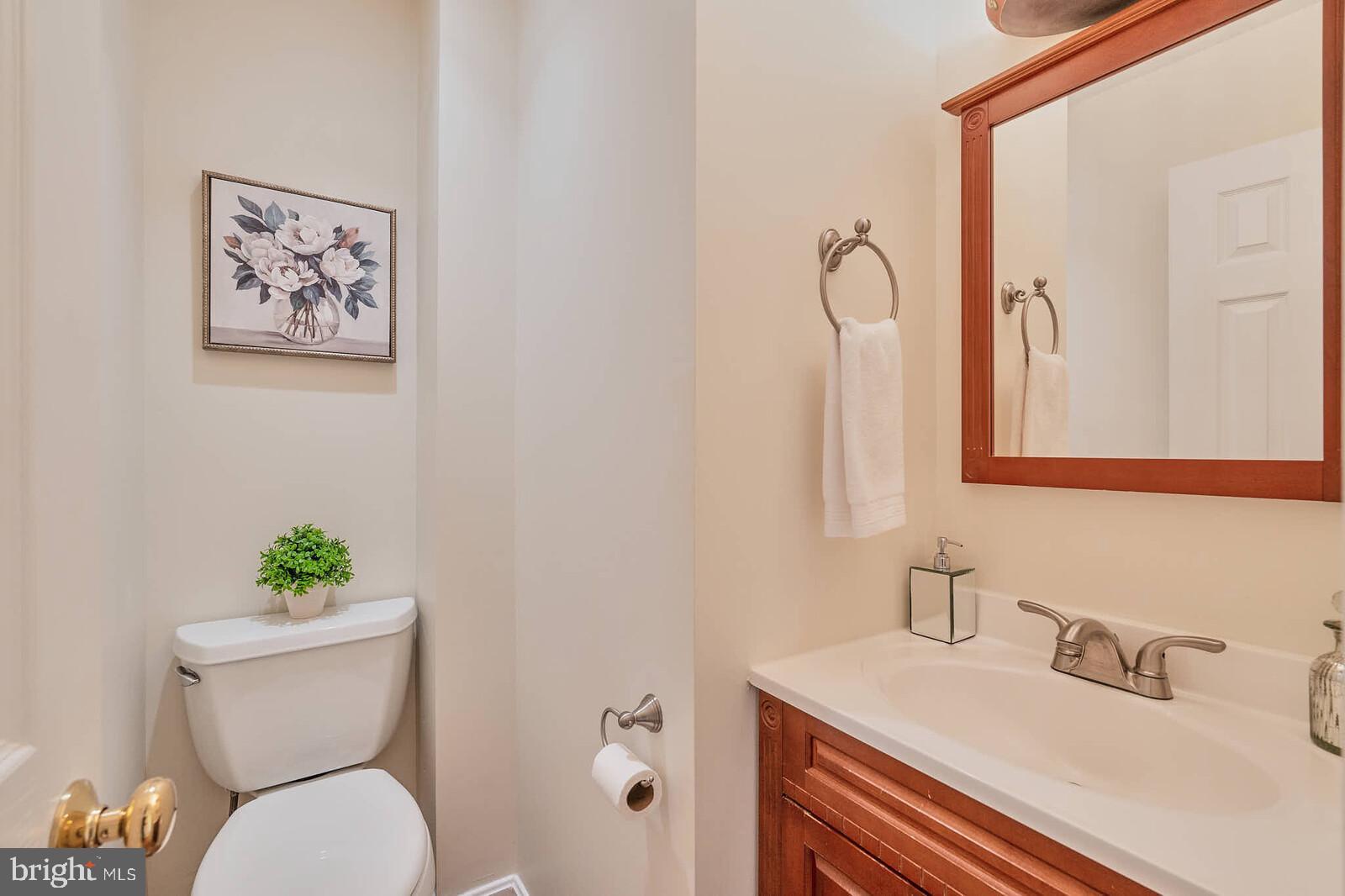 1912 Pagebrook Road Silver Spring, MD 20903 - Photo 20 of 52 a bathroom with a toilet sink and mirror