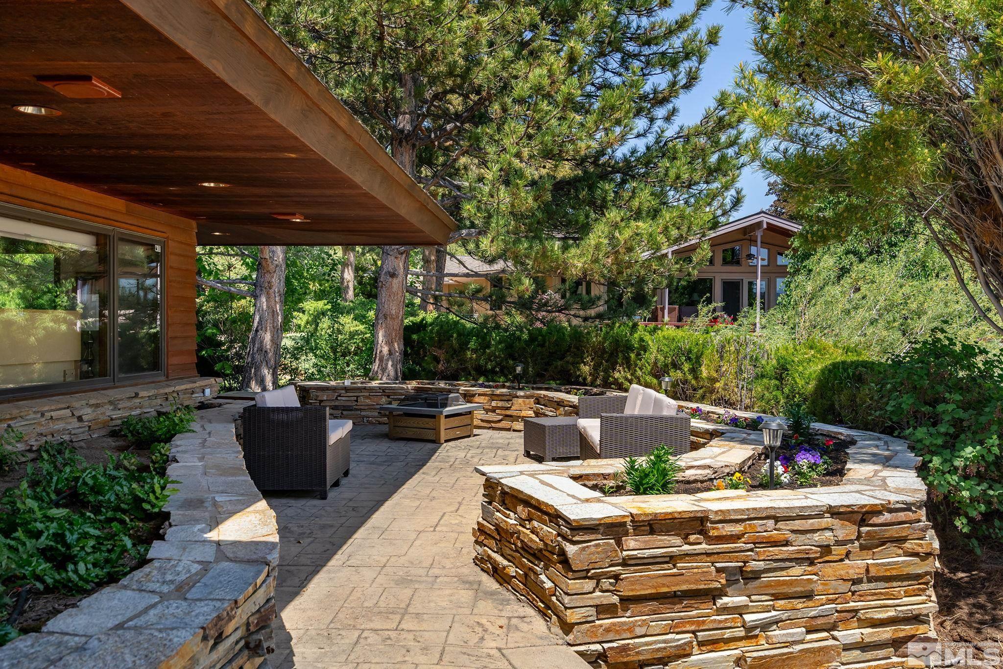 2800 East Lake Ridge Reno, NV 89519 - Photo 36 of 40 a view of a patio with couches a table and chairs and potted plants