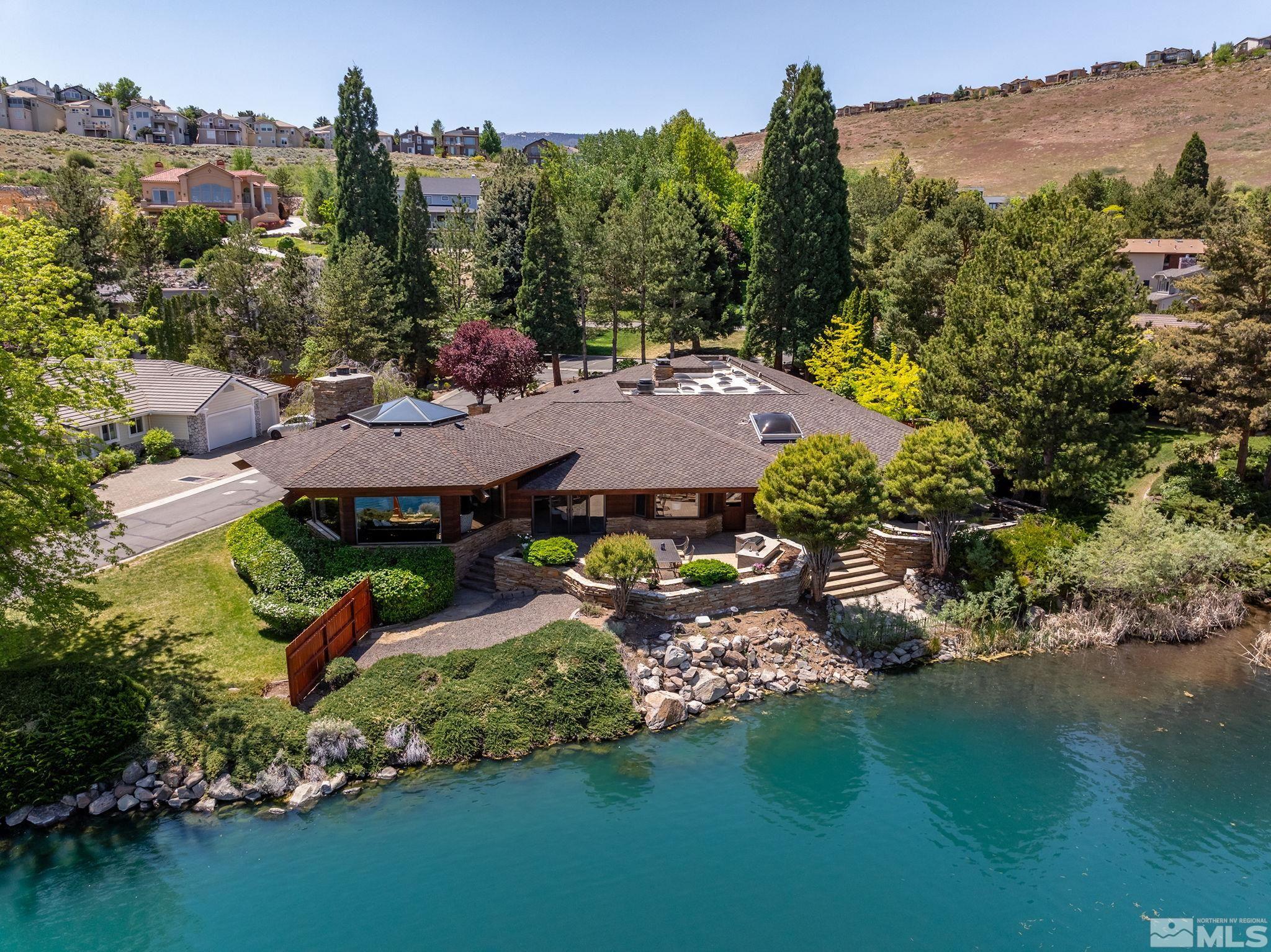 2800 East Lake Ridge Reno, NV 89519 - Photo 4 of 40 an aerial view of a house with garden space lake and mountain view in back