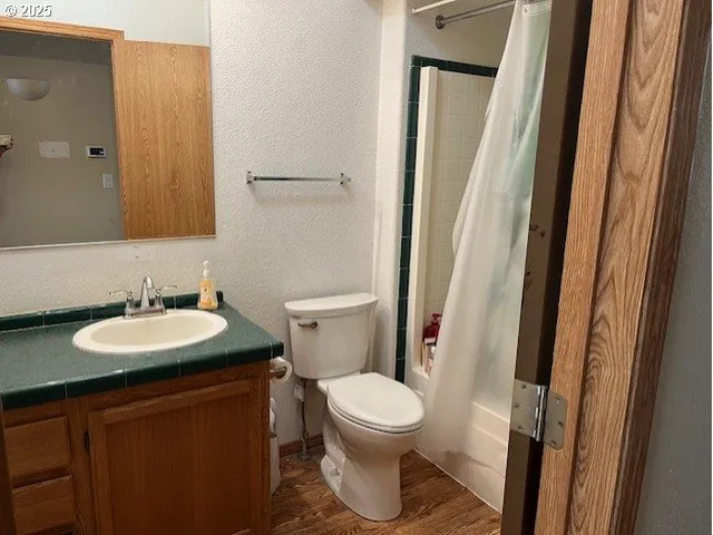 a bathroom with a toilet a sink and a mirror