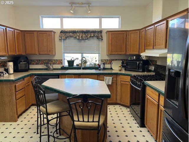 33399 Northwest Ej Smith Road Scappoose, OR 97056 - Photo 3 of 16 a kitchen with stainless steel appliances kitchen island granite countertop a sink a stove a refrigerator and cabinets