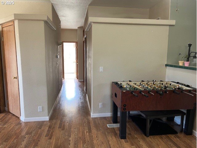 33399 Northwest Ej Smith Road Scappoose, OR 97056 - Photo 9 of 16 a view of a hallway with wooden floor and a fireplace