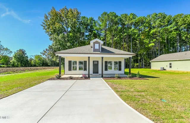 a front view of a house with swimming pool having outdoor seating
