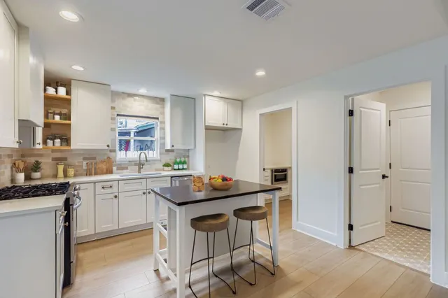 a kitchen with granite countertop a sink and appliances