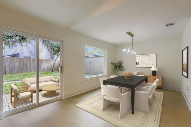 a view of a dining room with furniture window and wooden floor
