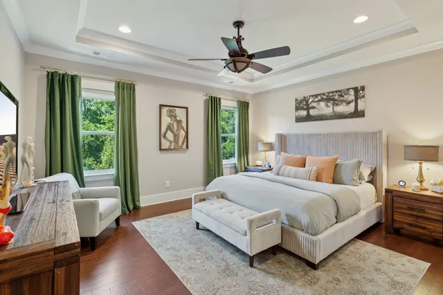 a bedroom with a bed couch and a large window