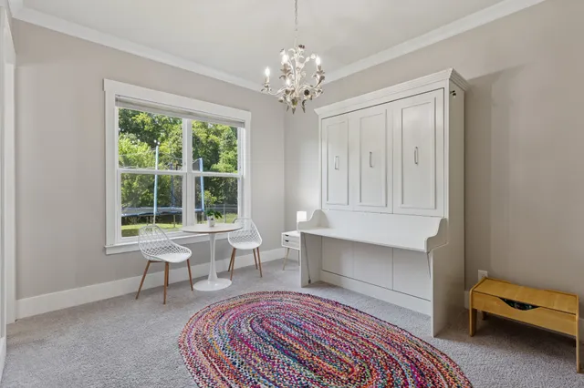 a living room with furniture and a chandelier