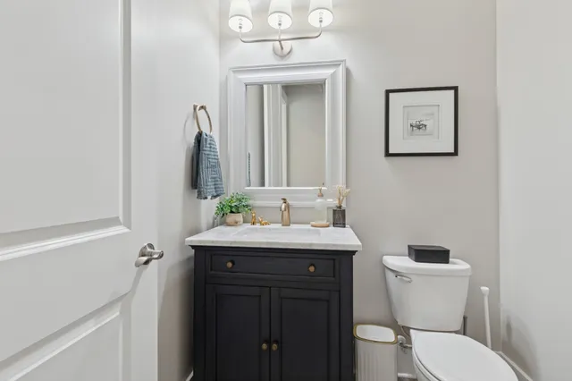 a bathroom with a toilet a sink and mirror
