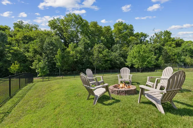 a view of a chairs in backyard of house