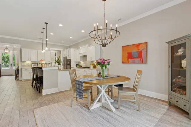 a view of a dining room with furniture wooden floor and chandelier