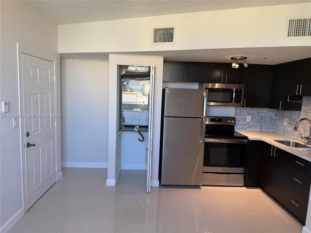a kitchen with stainless steel appliances a refrigerator and a sink