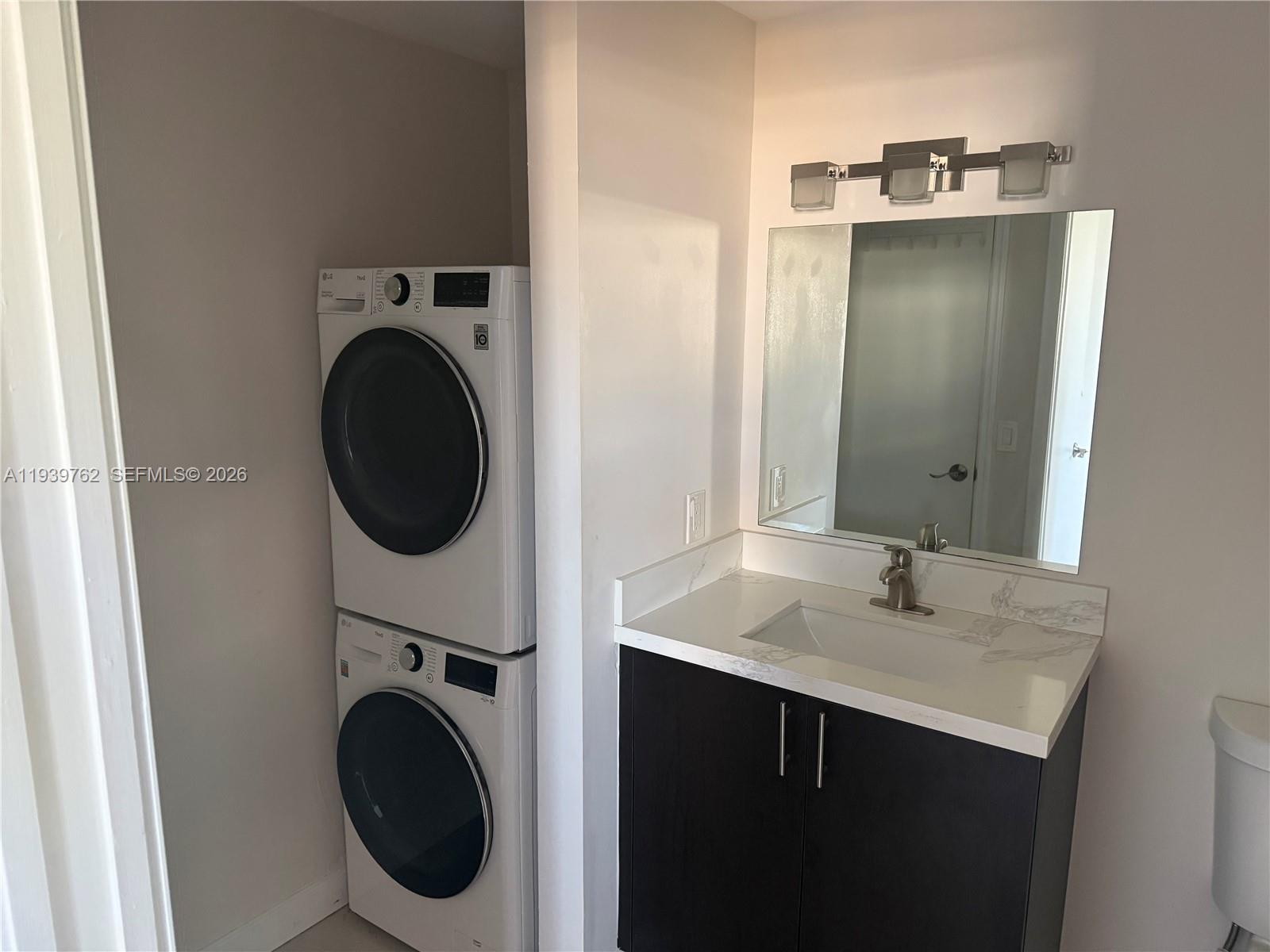 2630 Southwest 28th Street, Unit 47 Miami, FL 33133 - Photo 5 of 7 a bathroom with a sink and a mirror