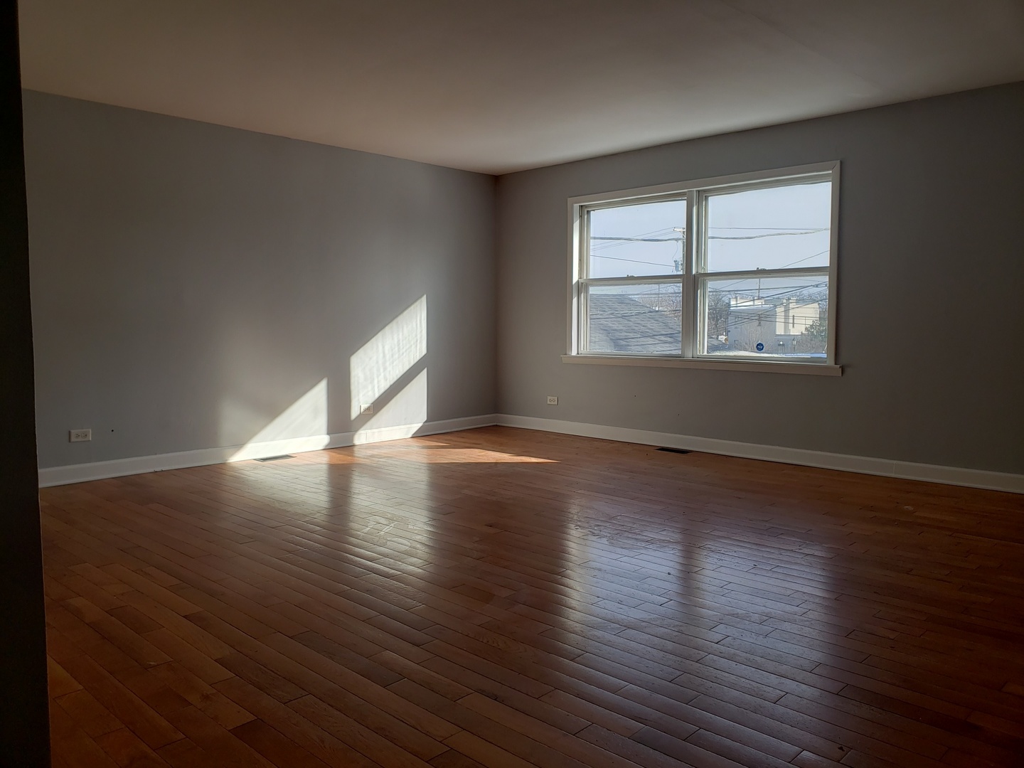 220 West Oneida Avenue Bartlett, IL 60103 - Photo 7 of 11 an empty room with wooden floor and windows