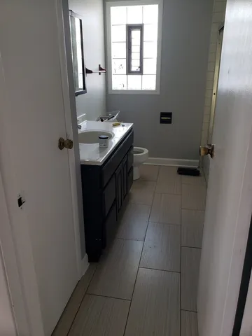 a bathroom with a sink vanity and a mirror