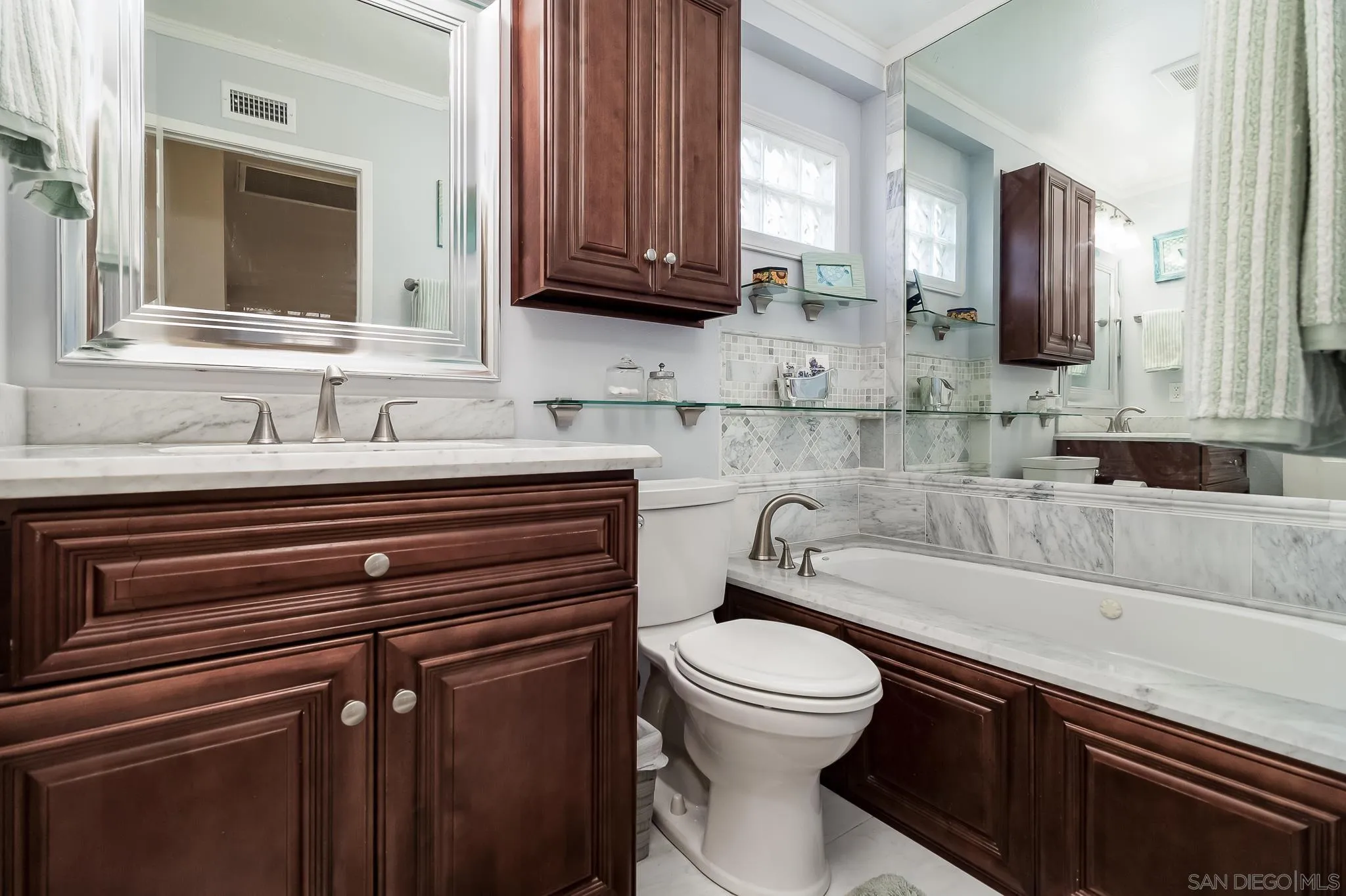 8537 Cordial Road El Cajon, CA 92021 - Photo 17 of 37 a bathroom with a sink a toilet and mirror