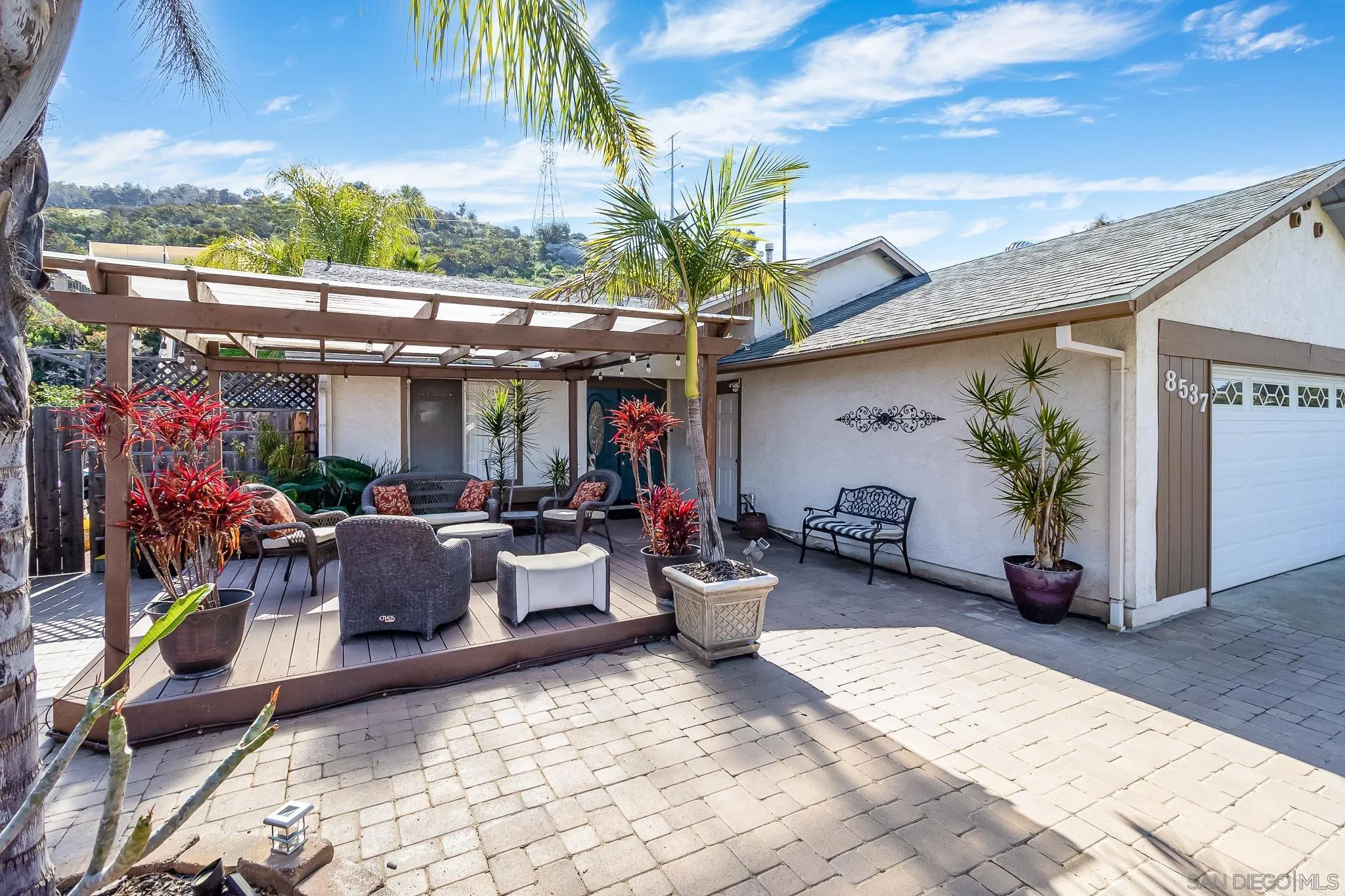 8537 Cordial Road El Cajon, CA 92021 - Photo 22 of 37 a view of a patio with table and chairs potted plants