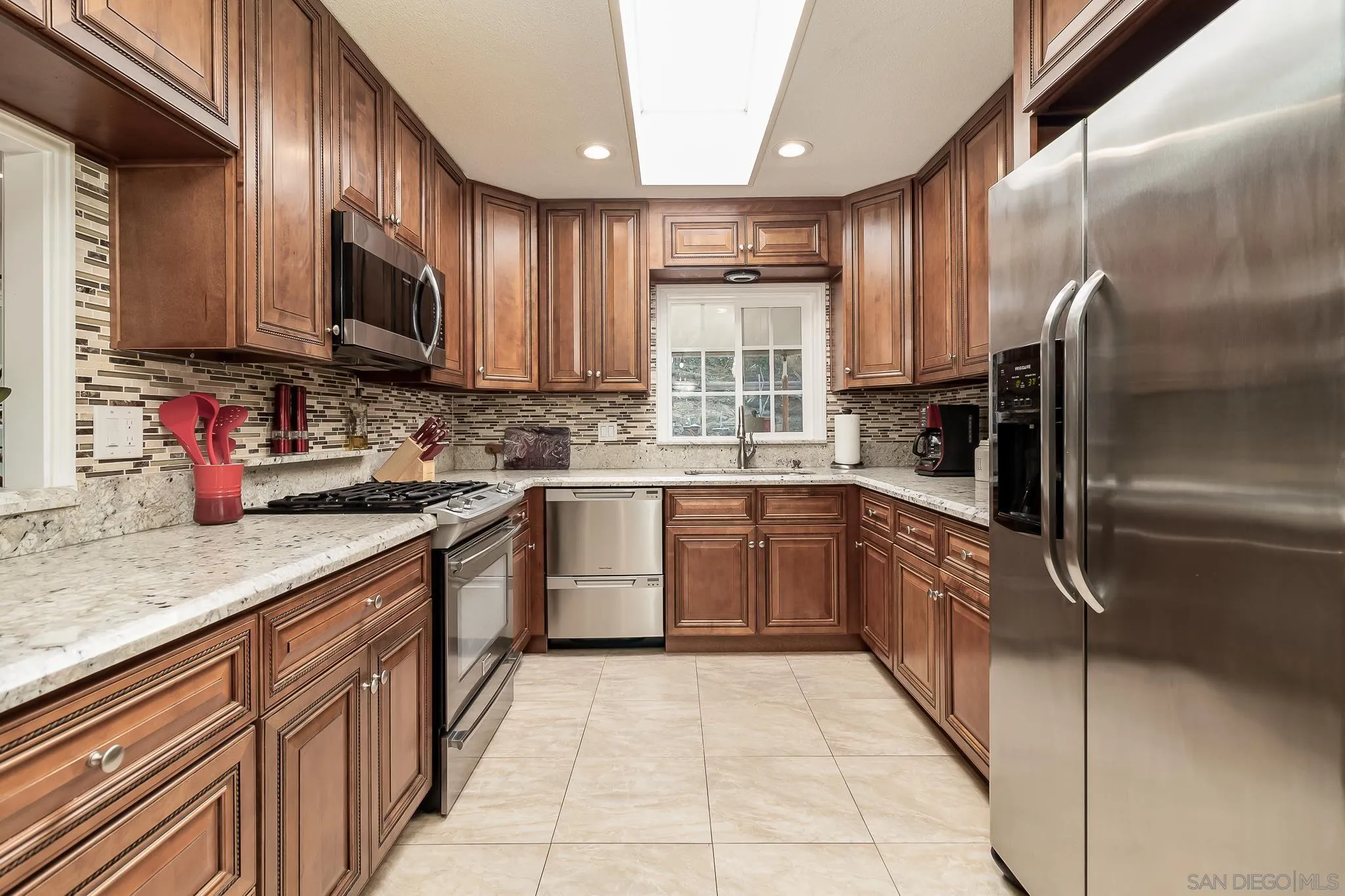 8537 Cordial Road El Cajon, CA 92021 - Photo 9 of 37 a kitchen with stainless steel appliances granite countertop a sink refrigerator and microwave