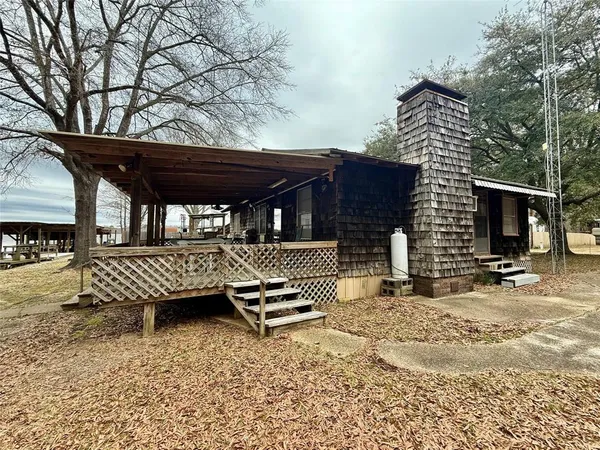 a view of a roof deck with wooden fence and a floor to ceiling window