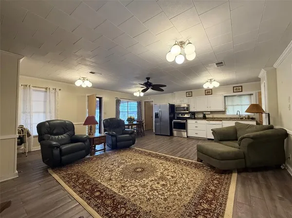 a living room with furniture and a chandelier