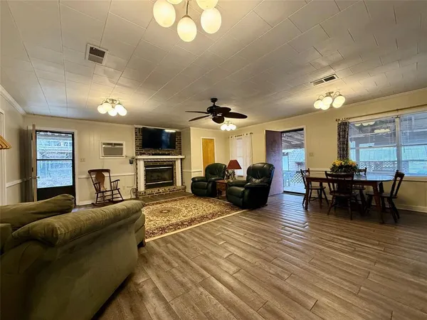 a living room with furniture a fireplace and a flat screen tv