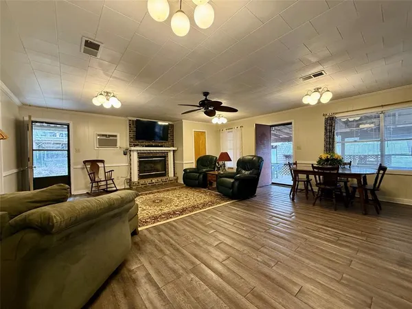 a living room with furniture fireplace and flat screen tv