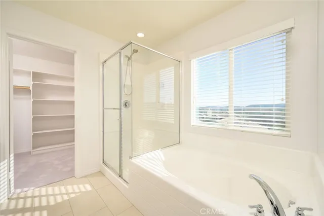 a spacious bathroom with a bathtub and a shower
