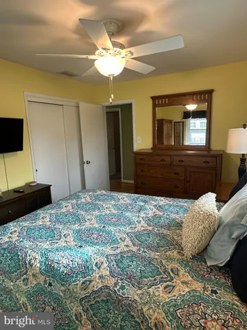 a bedroom with a bed and a television