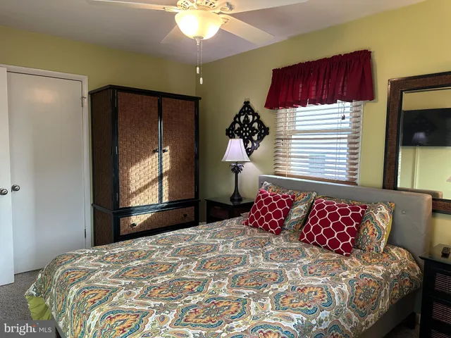 a bedroom with a bed and a mirror