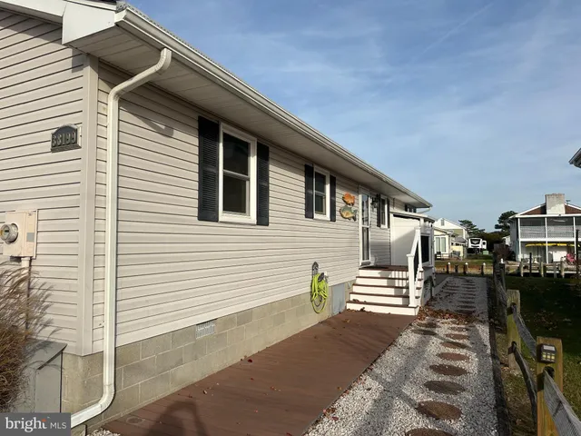 a backyard of a house with barbeque oven and wooden fence