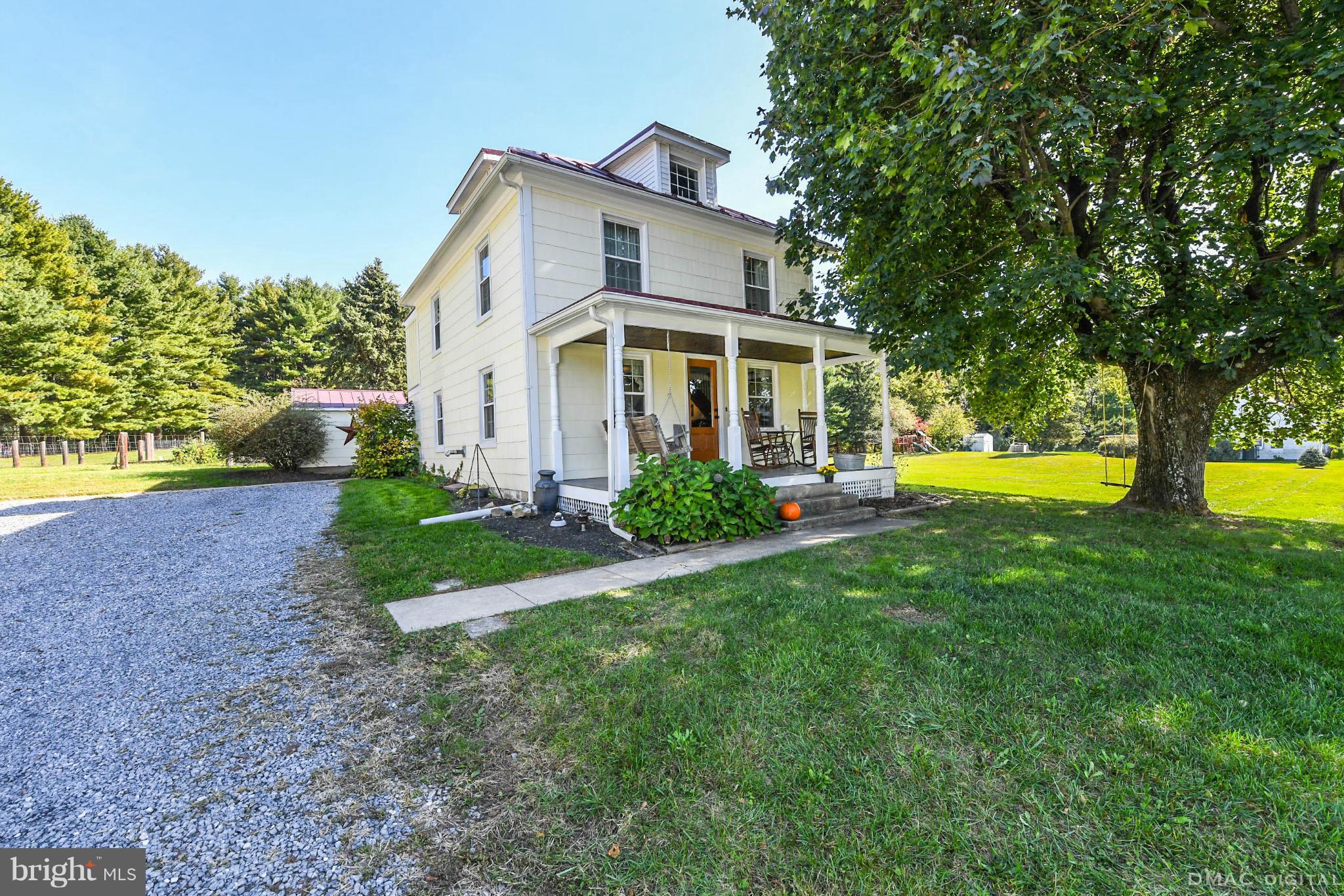8701 Yellow Springs Road, Unit C Frederick, MD 21702 - Photo 1 of 30 a front view of a house with a yard and trees