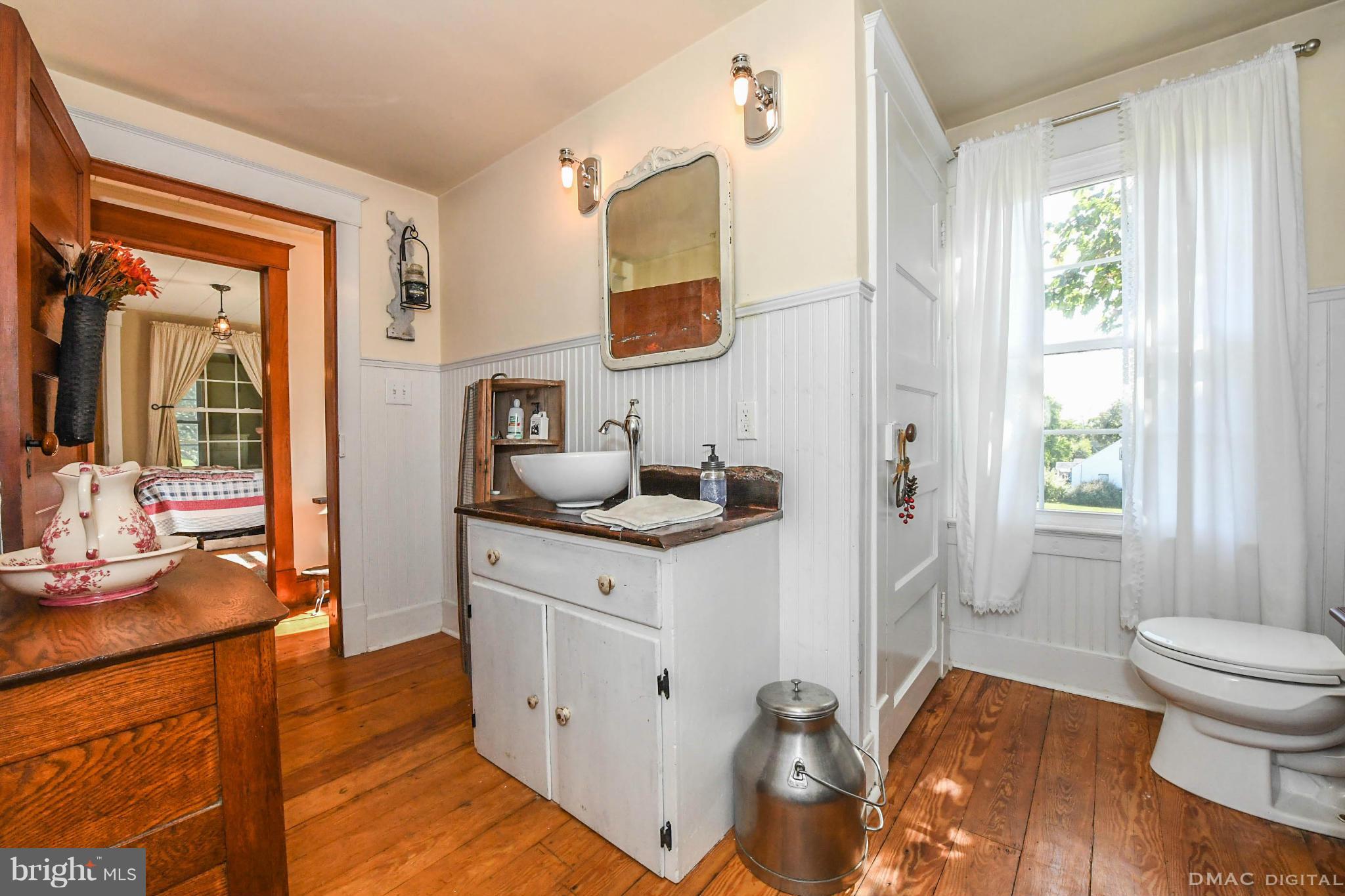 8701 Yellow Springs Road, Unit C Frederick, MD 21702 - Photo 13 of 30 a spacious bathroom with a granite countertop sink a toilet a mirror and shower
