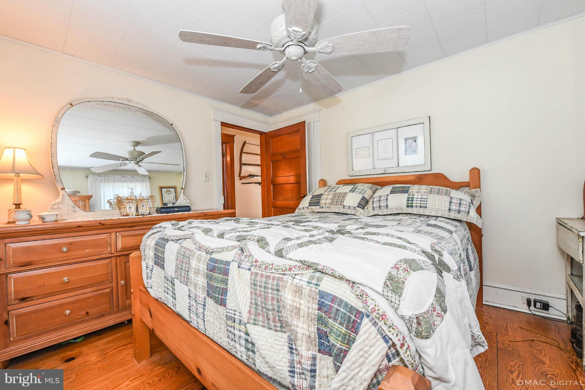 8701 Yellow Springs Road, Unit C Frederick, MD 21702 - Photo 15 of 30 a bedroom with a bed and a mirror on the dresser