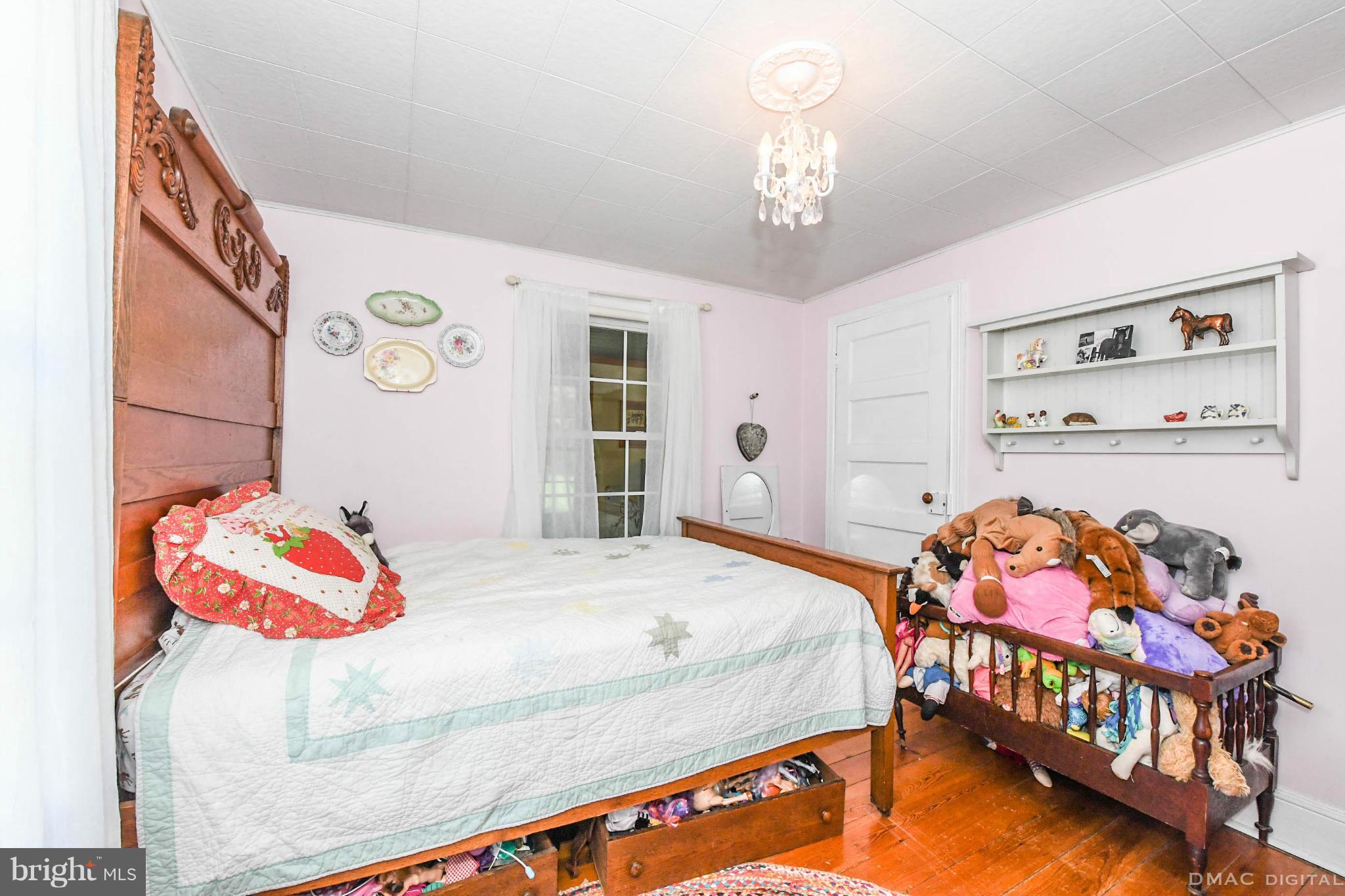 8701 Yellow Springs Road, Unit C Frederick, MD 21702 - Photo 19 of 30 a bedroom with a bed and dresser