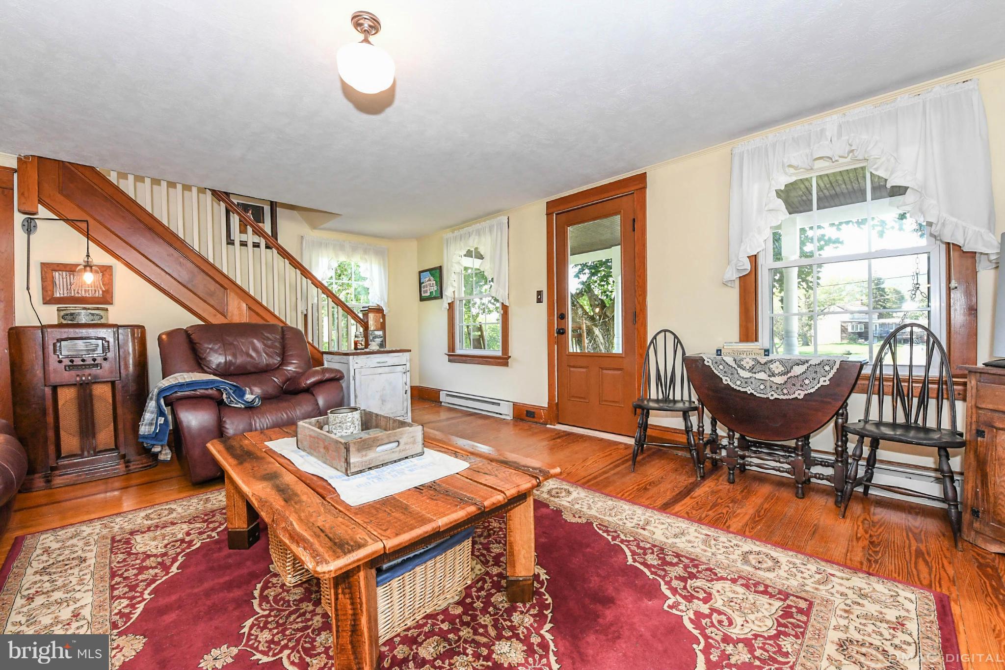 8701 Yellow Springs Road, Unit C Frederick, MD 21702 - Photo 6 of 30 a living room with furniture a dining table and chairs with wooden floor