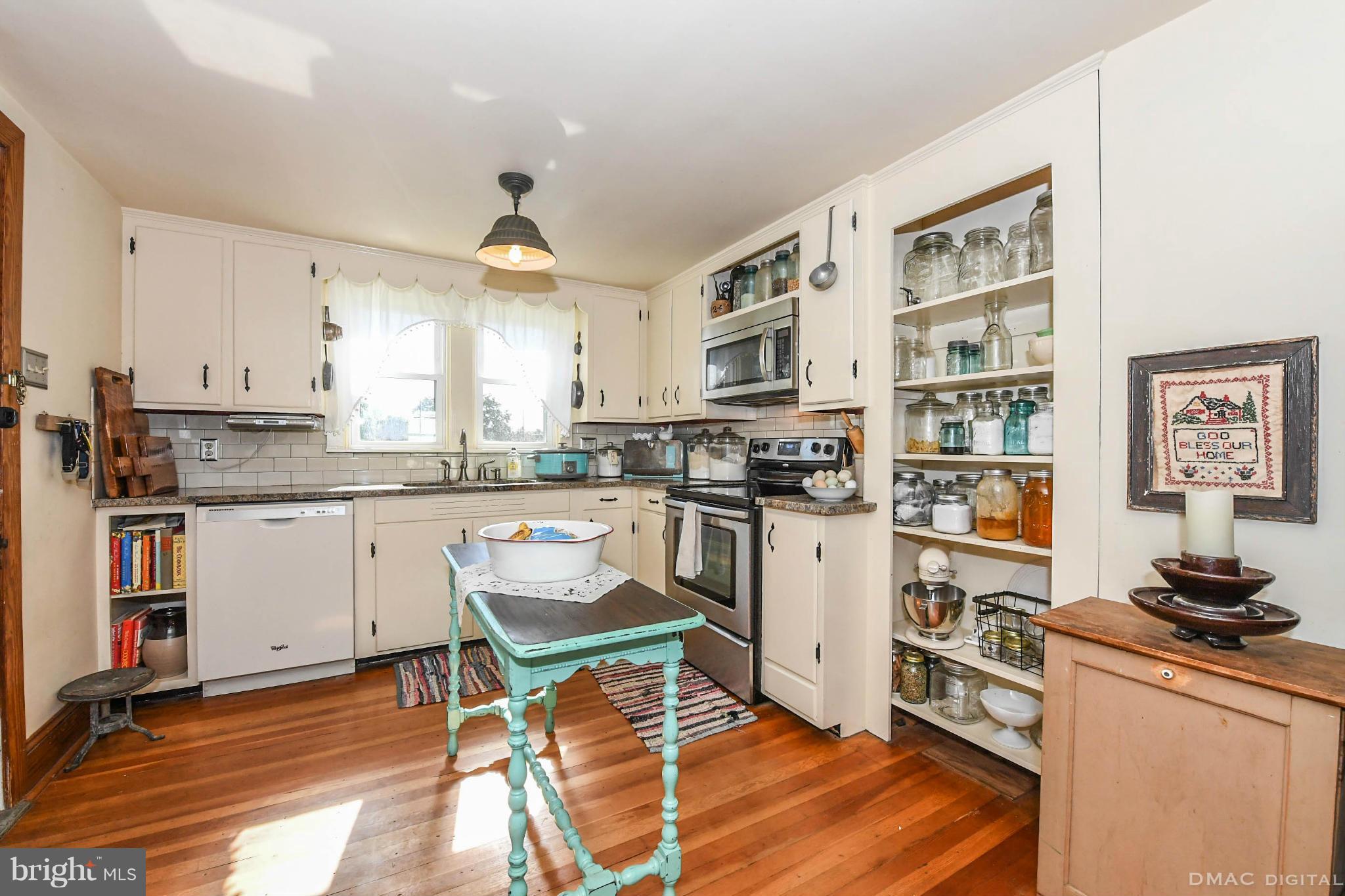 8701 Yellow Springs Road, Unit C Frederick, MD 21702 - Photo 8 of 30 a kitchen with stainless steel appliances granite countertop a stove top oven a sink dishwasher and white cabinets with wooden floor